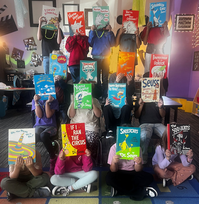 Kids holding up their books